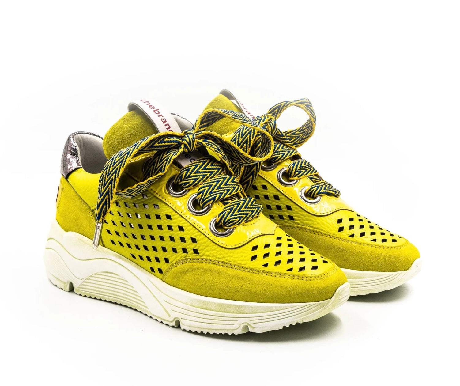 neon colored perforated platform sneaker with metallic back detail and patterned laces pair