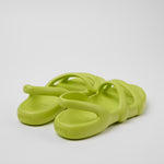 Light green molded modern flat sandal pair from back