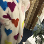 Colorful heart-patterned fabric with a blurred background
