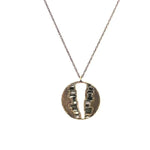 V cut-out round medallion necklace. Featuring an antique brass finish with baguette crystals. 16" chain with lobster clasp closure. Handcrafted in Brooklyn.