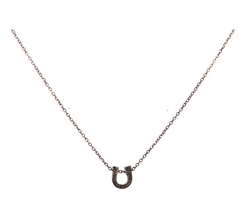 mini horseshoe pendant necklace features black diamond detailing on fine chain. Handmade in New York.
