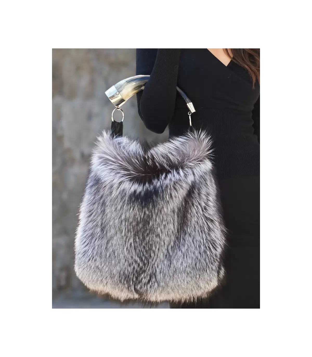 Genuine silver black fox fur handbag with cow horn handle featured on model. Made in the USA.