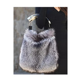 Genuine silver black fox fur handbag with cow horn handle featured on model. Made in the USA.