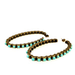 burnished oval hoop earrings feature an antique brass finish with semi precious stones. Handmade in Brooklyn.