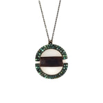 pendant of this necklace includes two half circles encrusted with African turquoise and connected by leather. Handcrafted in New York.