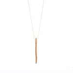 quirky stick pendant necklace features 18K gold finish with black diamond crystal accents on a 16" delicate chain with lobster clasp closure. Handmade in New York.