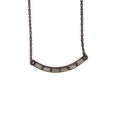 curved crystal bar necklace features an antique brass finish with black baguette diamond crystal accents on 12" chain with a lobster clasp closure. Handmade in New York.
