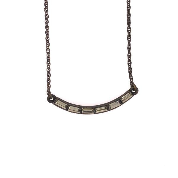 curved crystal bar necklace features an antique brass finish with black baguette diamond crystal accents on 12" chain with a lobster clasp closure. Handmade in New York.