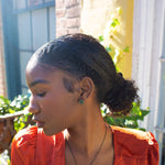 Rebel cluster stud earrings. Antique brass finish with African turquoise beads. Handmade in New York. Featured on model