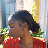 Rebel cluster stud earrings. Antique brass finish with African turquoise beads. Handmade in New York. Featured on model