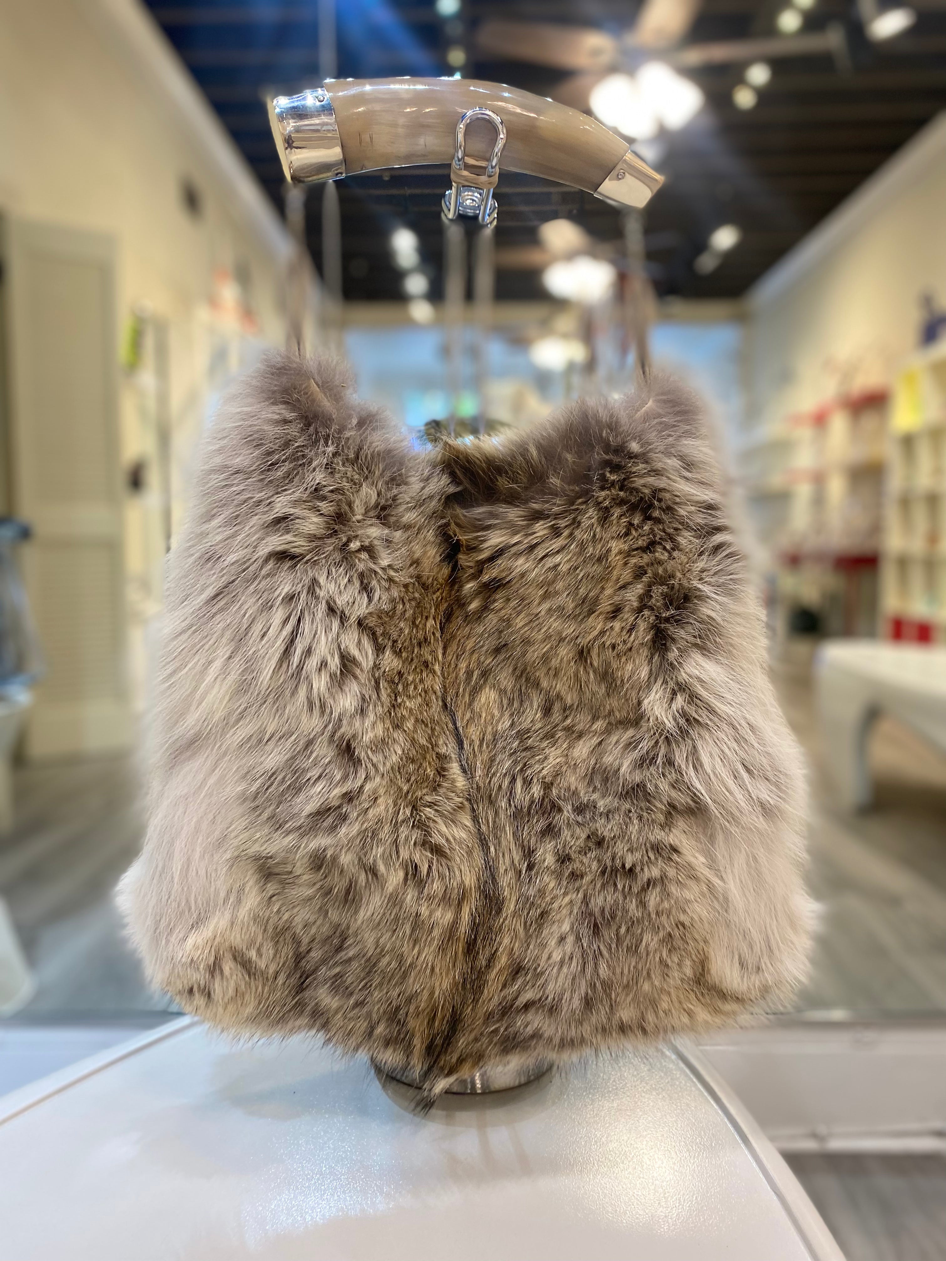 Genuine coyote fur handbag with cow horn handle featured in store. Made in the USA.