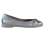 Silver flat shoe with a gold buckle on a white background