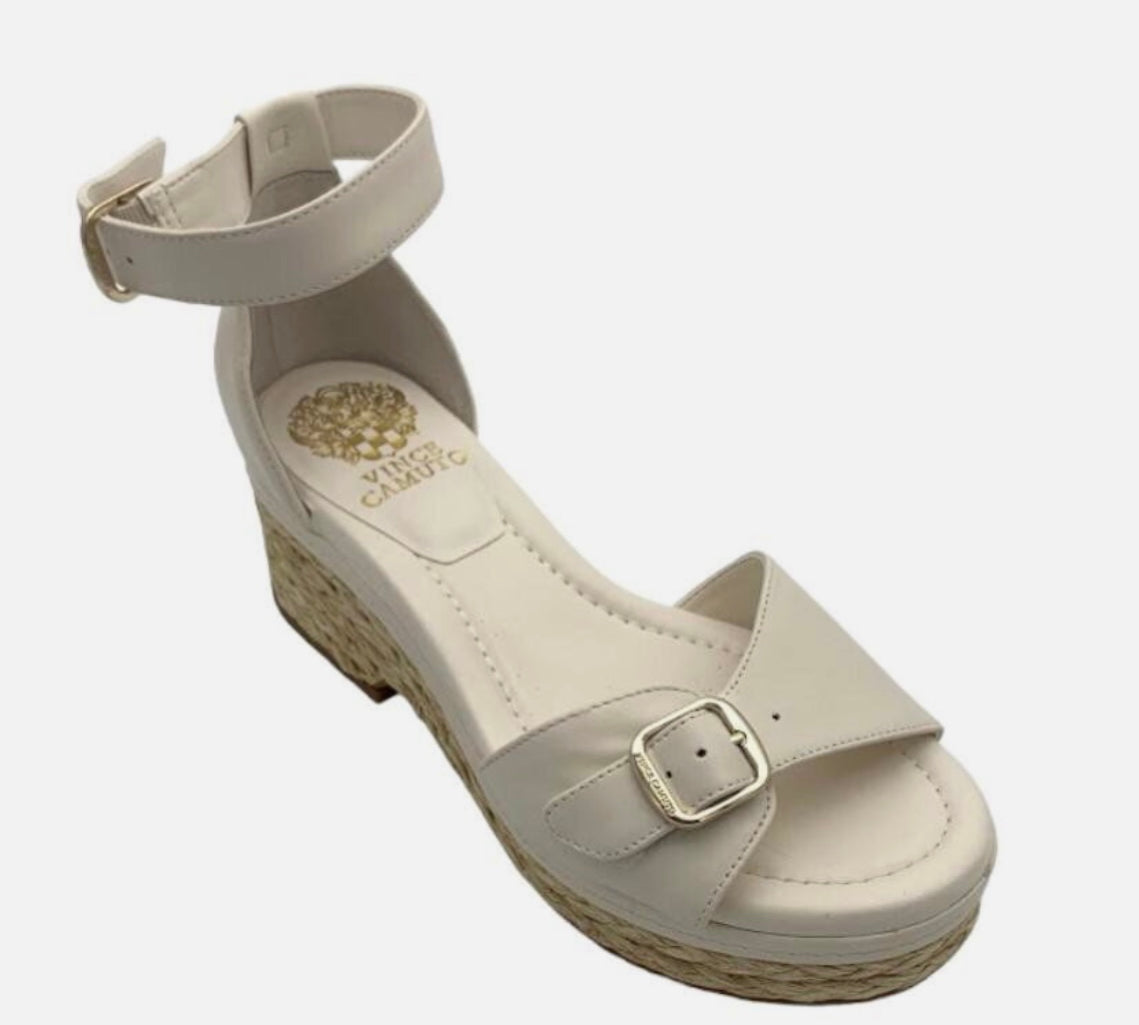 black wedge heel sandal with brassy buckle closure and raffia bottom detail