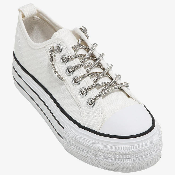 white low top sneaker with black strip detail and rhinestone laces profile