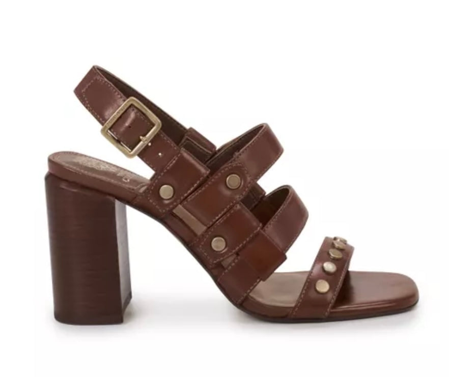 Brown chunky strapped heeled sandal made of luxe soft nubuck leather embellished with flat studs. Has adjustable slingback strap. 