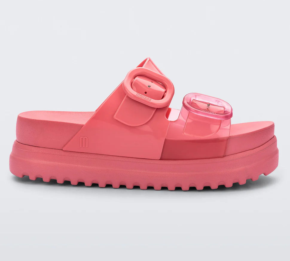 salmon colored platform slip on slide sandals with buckle straps side view