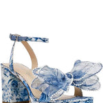 blue and white floral heeled sandal with large bow and buckled strap by Betsey Johnson profile view