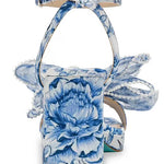 blue and white floral heeled sandal with large bow and buckled strap by Betsey Johnson back view