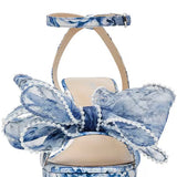 blue and white floral heeled sandal with large bow and buckled strap by Betsey Johnson front view