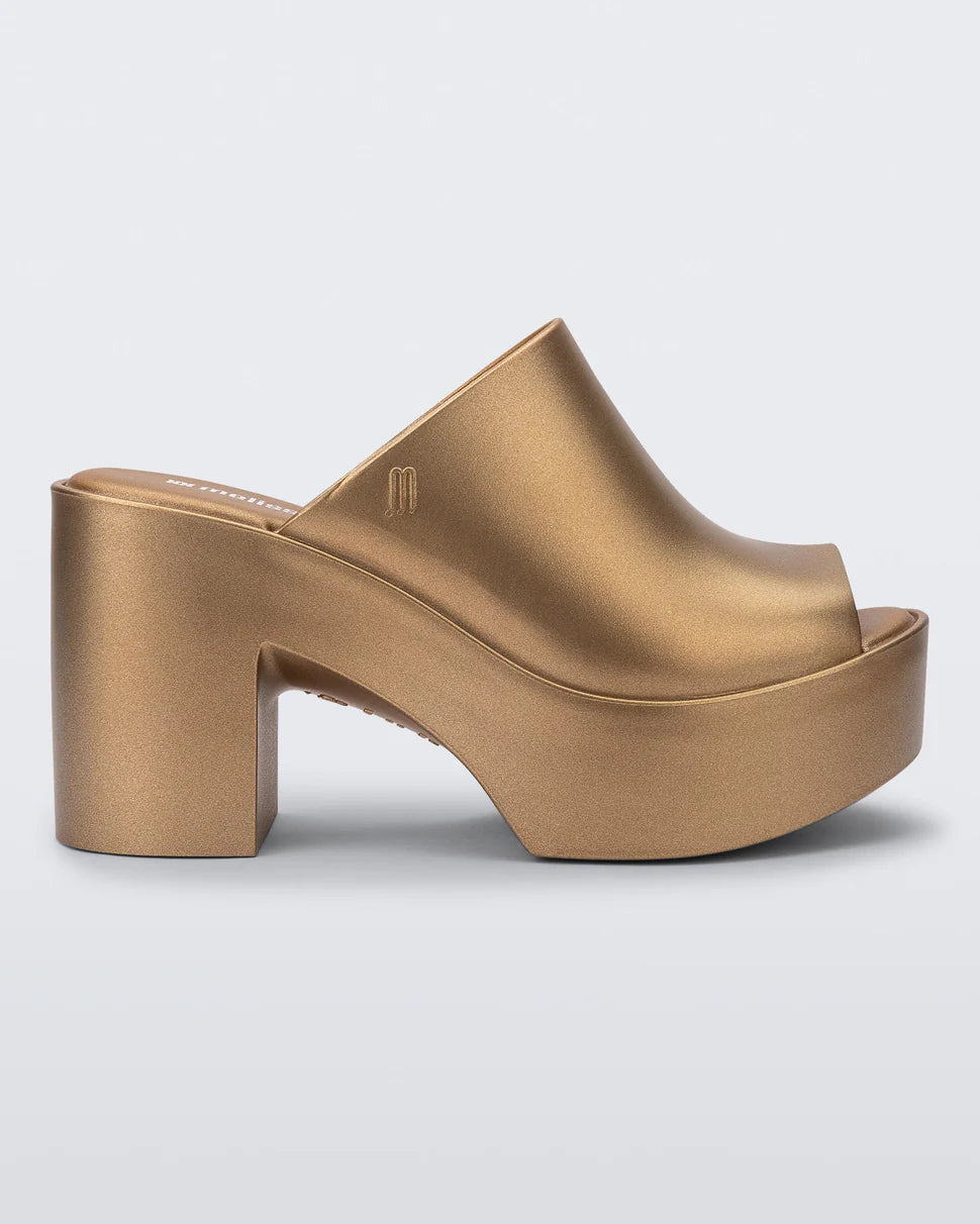 gold colored bubblegum scented heeled mule slip on sandal profile
