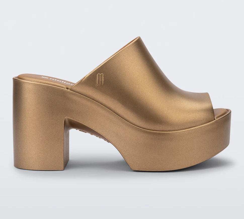 gold colored bubblegum scented heeled mule slip on sandal profile