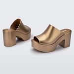 gold colored bubblegum scented heeled mule slip on sandal pair
