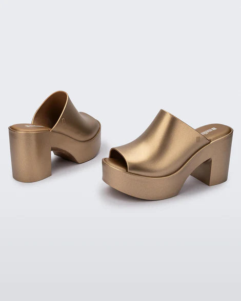 gold colored bubblegum scented heeled mule slip on sandal pair