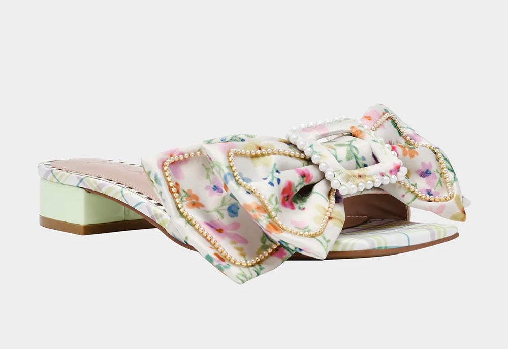 block heel slip on sandal with floral print and oversized bow adorned with pearl like beading side front