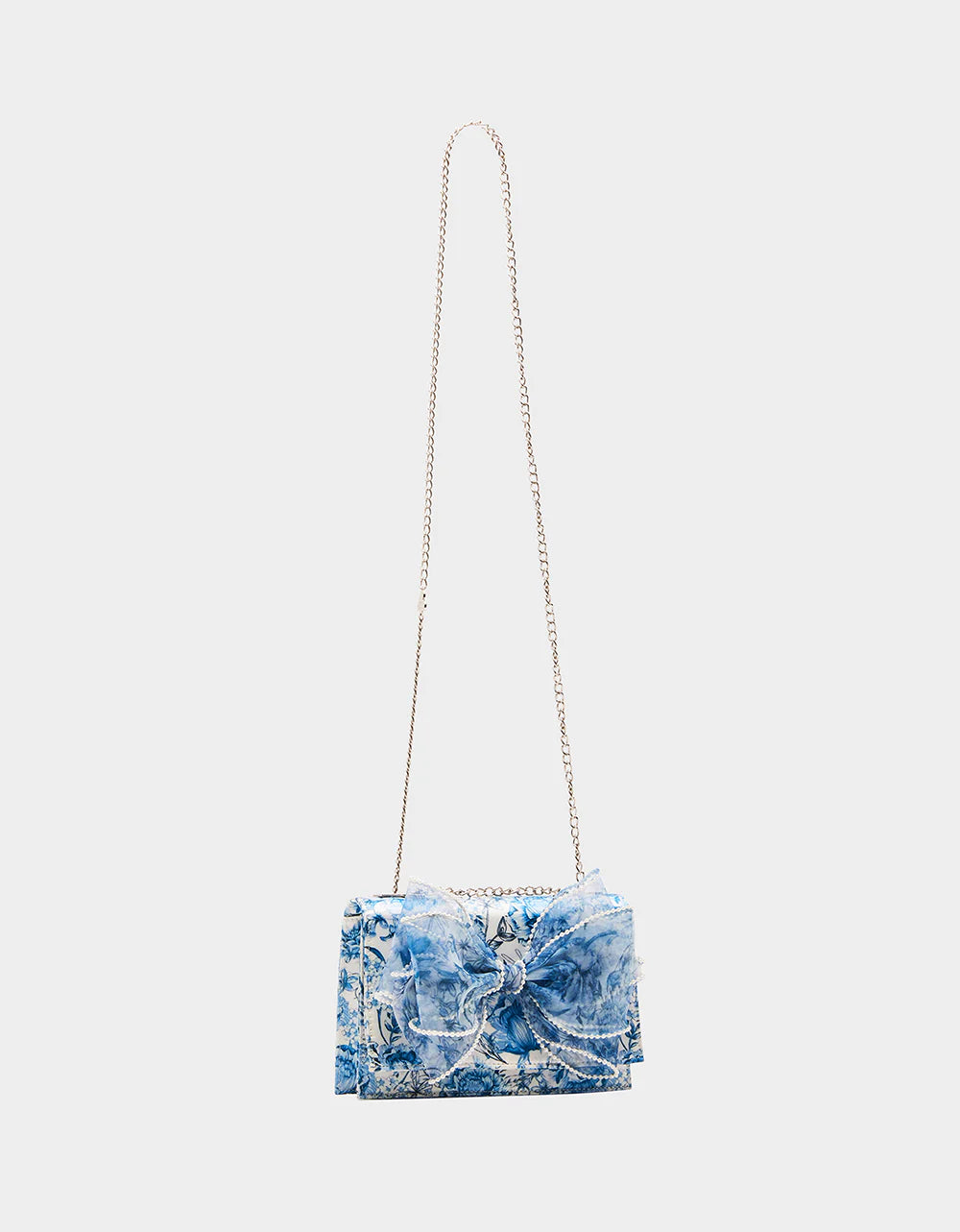blue and white floral print hand bag with oversized bow that has pearl like detail full strap