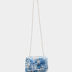 blue and white floral print hand bag with oversized bow that has pearl like detail full strap