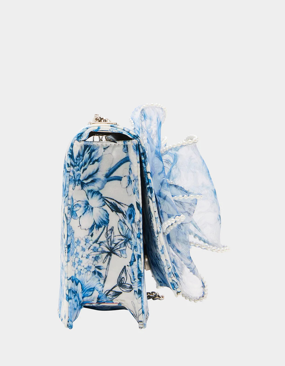blue and white floral print hand bag with oversized bow that has pearl like detail side view