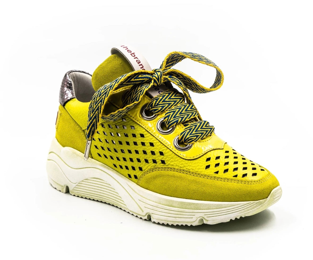 neon colored perforated platform sneaker with metallic back detail and patterned laces side view