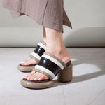 Brown, black, and white bubble modern backless heel sandal close up pair on model