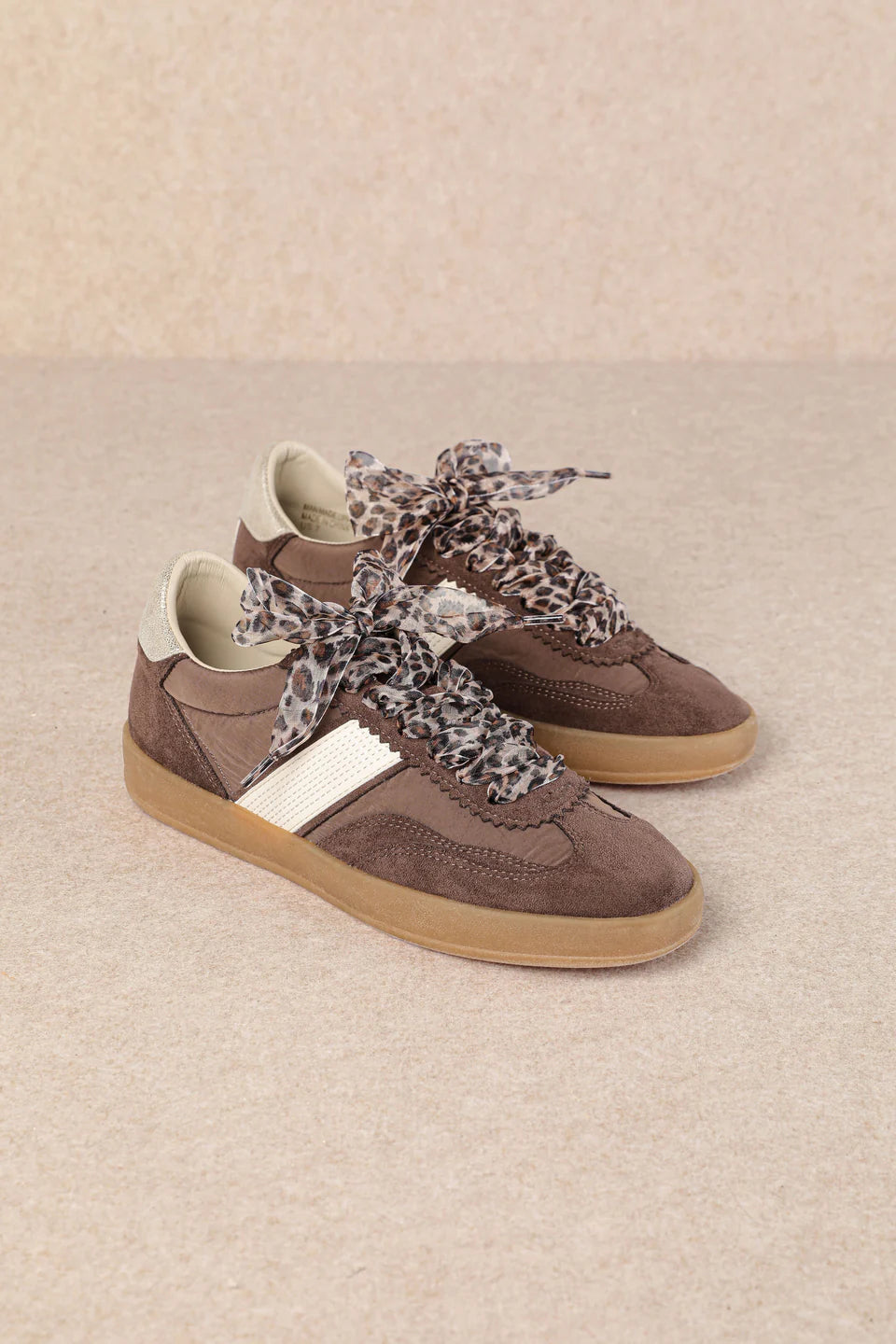 brown and white faux leather sneaker with animal print lace shoe lace detail pair side profile