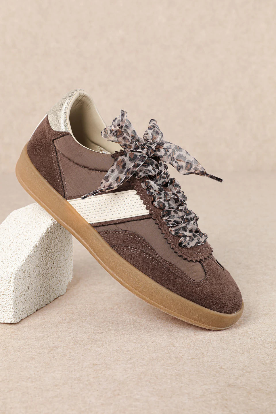 brown and white faux leather sneaker with animal print lace shoe lace detail side profile