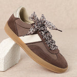 brown and white faux leather sneaker with animal print lace shoe lace detail side profile