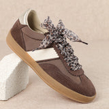 brown and white faux leather sneaker with animal print lace shoe lace detail side profile