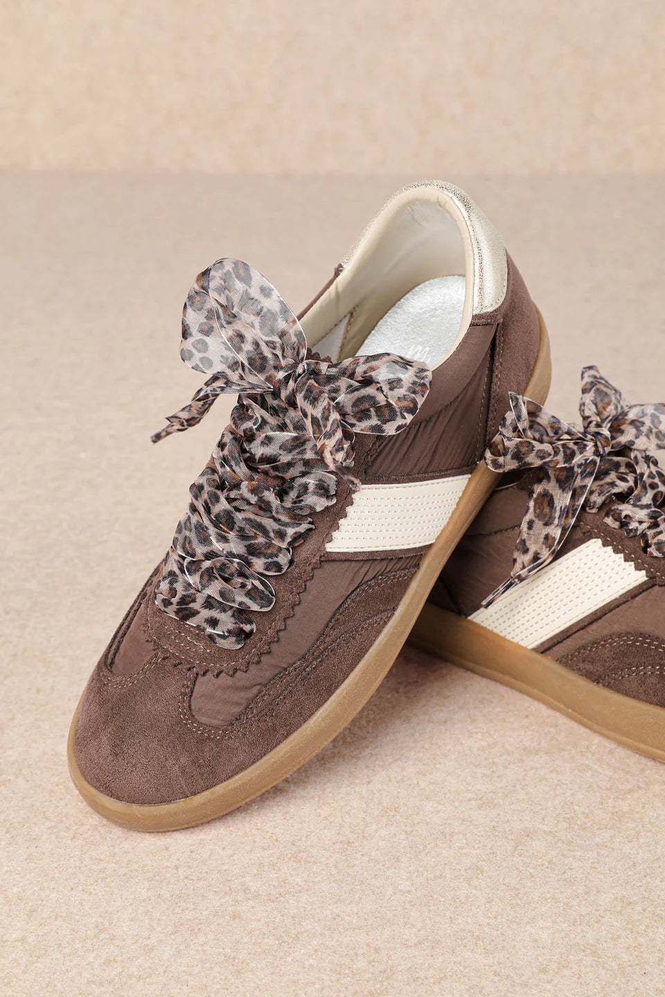brown and white faux leather sneaker with animal print lace shoe lace detail pair