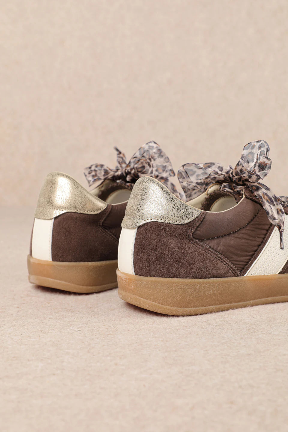 brown and white faux leather sneaker with animal print lace shoe lace detail pair back profile