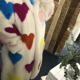Colorful heart-patterned fabric with a blurred background