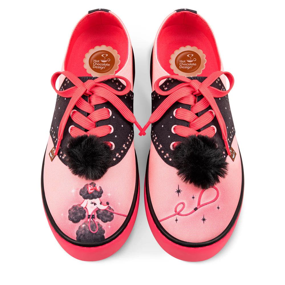 Pink and black sneakers with red laces and black pom-poms featuring a poodle holding a leash in its mouth on a white background