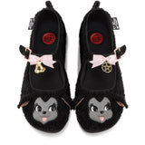 Black furry mary janes with cartoon lamb faces and decorative bow, bell, and pentagram elements on a white background
