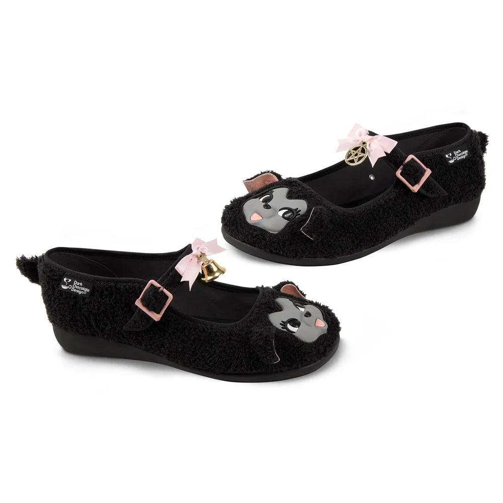 Black furry mary janes with cartoon lamb faces and decorative bow, bell, and pentagram elements on a white background side by side