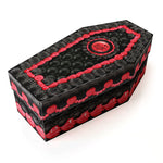 Black coffin-shaped shoe box with red decorative icing like elements on a white background