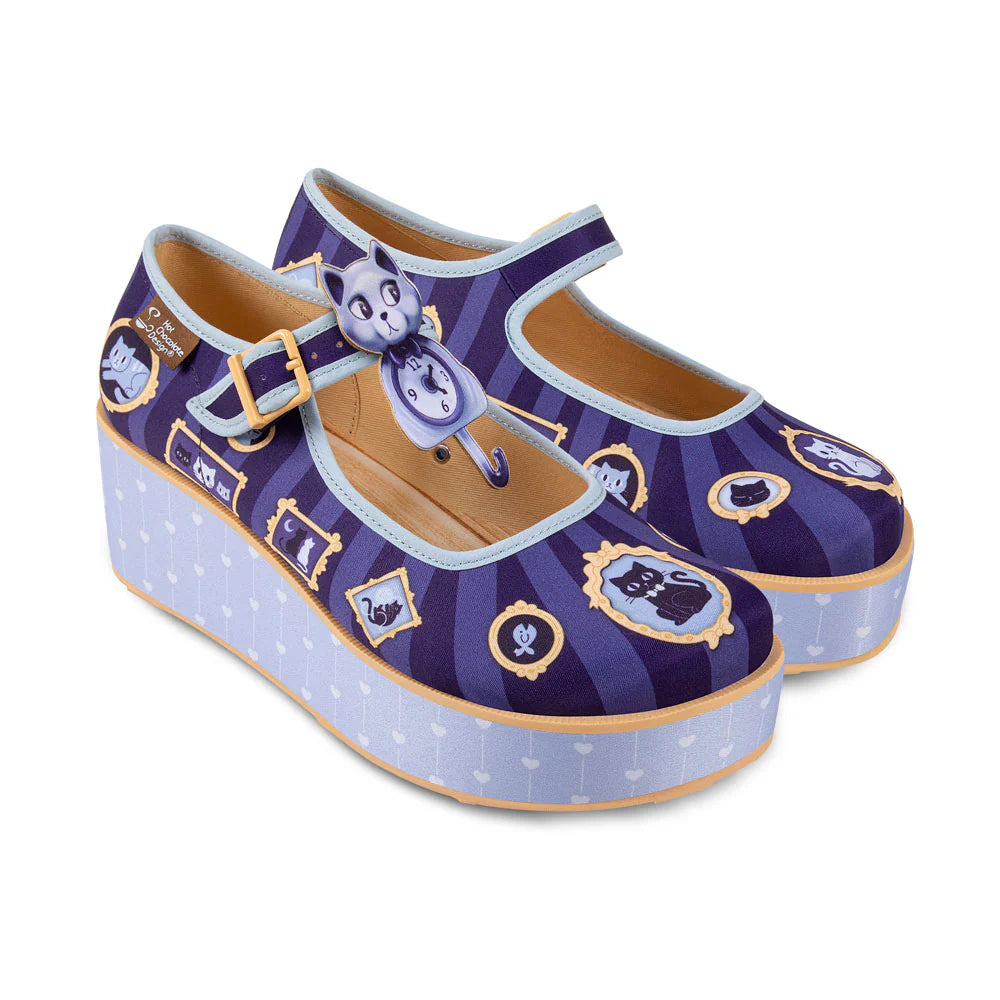 Pair of purple mary jane platform shoes with cat designs, and across the foot buckles on a white background side profile