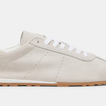 Italian-made sneaker featuring a trendy silhouette in ultra-soft suede. The SERINA sneaker in ivory features a rubber sole and white shoe laces close up