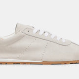 Italian-made sneaker featuring a trendy silhouette in ultra-soft suede. The SERINA sneaker in ivory features a rubber sole and white shoe laces close up