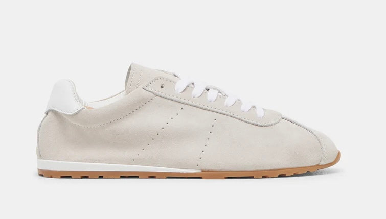 Italian-made sneaker featuring a trendy silhouette in ultra-soft suede. The SERINA sneaker in ivory features a rubber sole and white shoe laces close up
