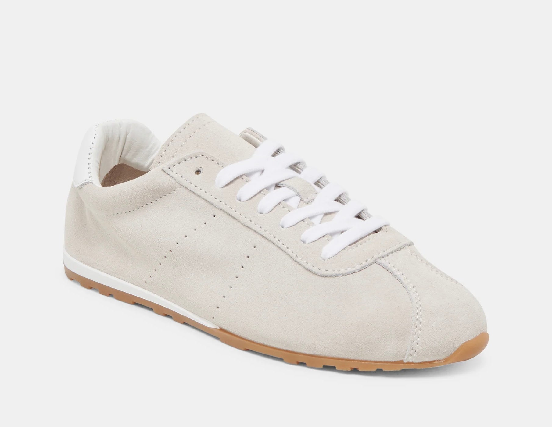 Italian-made sneaker featuring a trendy silhouette in ultra-soft suede. The SERINA sneaker in ivory features a rubber sole and white shoe laces side profile