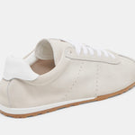 Italian-made sneaker featuring a trendy silhouette in ultra-soft suede. The SERINA sneaker in ivory features a rubber sole and white shoe laces back profile.